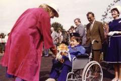 HRH receiving a bouquet from Andrea